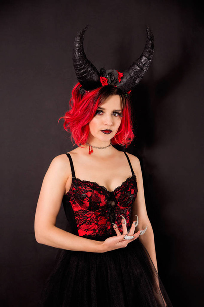 Red-haired model with horns. Halloween - Фото, зображення