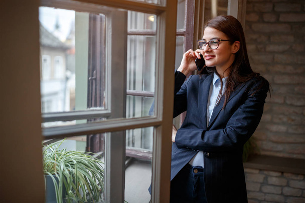 Female manager having business phone conversation in office - Fotografie, Obrázek
