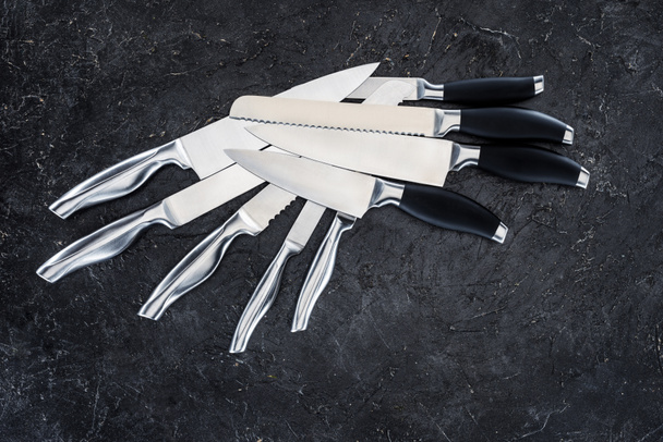 set of various kitchen knives arranged on black, top view   - Fotografie, Obrázek