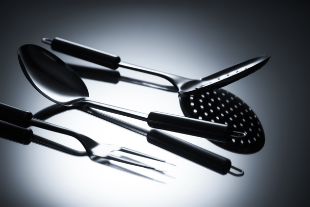 close-up view of colander, fork with two tines and ladle on grey - Photo, Image