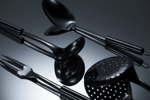 close-up view of shiny stainless steel utensils reflected on grey - Fotografie, Obrázek