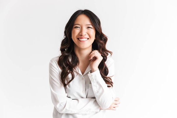 Portrait of gorgeous asian woman with long dark hair laughing at camera with beautiful smile isolated over white background in studio - Valokuva, kuva