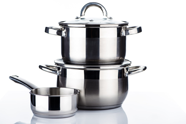 close-up view of shiny stainless steel pots and pans on white  - Photo, Image