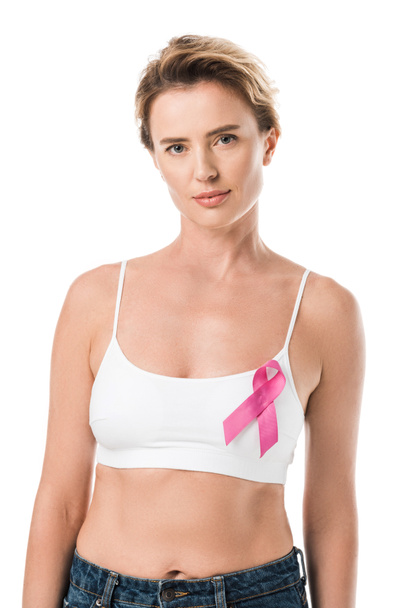 woman in underwear with pink ribbon looking at camera isolated on white, breast cancer awareness concept   - Фото, изображение