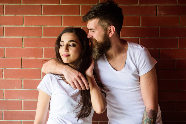 Moments of intimacy. Couple find place to be alone. Couple in love hugs brick wall background. Girl and hipster romantic date intimacy moment. Couple enjoy intimacy cuddling without witnesses - Photo, Image