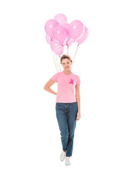 woman holding pink balloons and smiling at camera isolated on white, breast cancer concept   - Фото, изображение