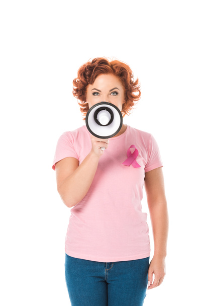 woman in pink t-shirt with breast cancer awareness ribbon holding megaphone and looking at camera isolated on white - Photo, Image