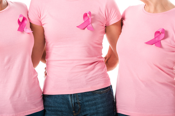 partial view of women with pink ribbons standing together isolated on white, breast cancer awareness concept  - 写真・画像