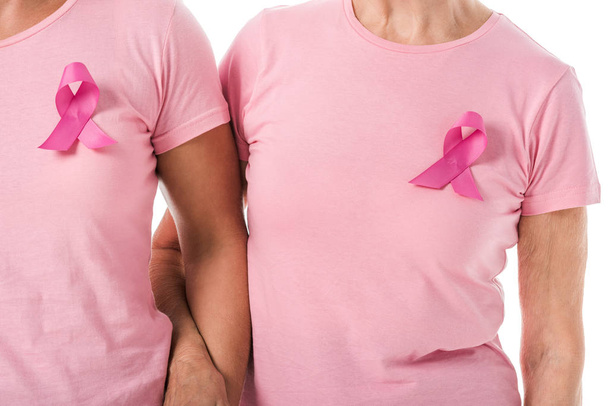 cropped shot of women with pink ribbons holding hands isolated on white, breast cancer awareness concept - Foto, Imagen