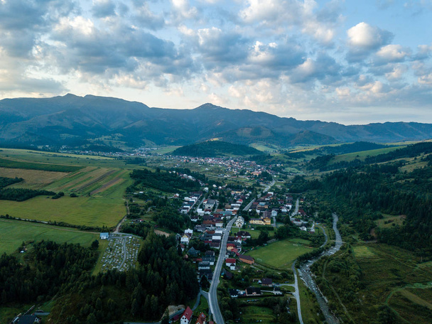 drone image. aerial view of rural mountain area in Slovakia, villages of Zuberec and Habovka from above. dramatic sunset over the mountain with clouds - Foto, immagini