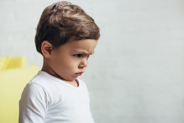 portrait of little offended boy in bad mood at home - Fotó, kép