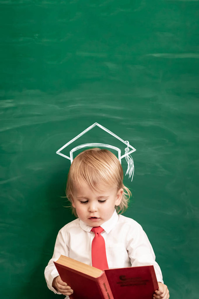 Happy child in class. Funny kid against chalkboard. Back to school. Education concept - Fotografie, Obrázek