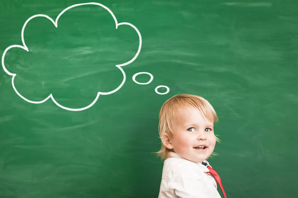 Happy child in class. Funny kid against chalkboard. Back to school. Education concept - Foto, Imagem