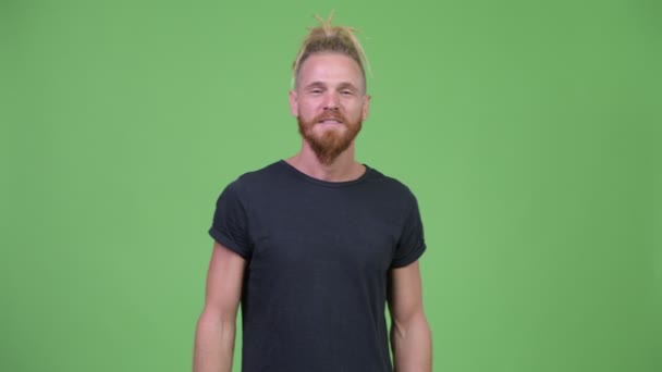 Happy handsome bearded man with dreadlocks looking excited - Materiał filmowy, wideo
