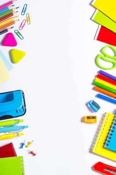 School and office supplies on white background. Notebook, notepad, pen, pencils, paper clips and stuff. Top view with copy space. - Foto, Bild