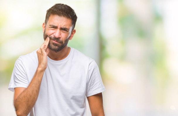 Adult hispanic man over isolated background touching mouth with hand with painful expression because of toothache or dental illness on teeth. Dentist concept. - Photo, Image