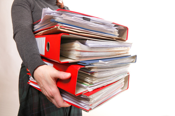 Female office worker carrying a stack of files - Photo, Image