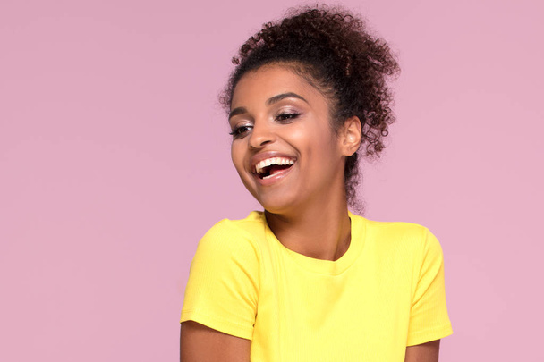 Excited african american woman smiling, posing on pink pastel background. - Foto, Imagen