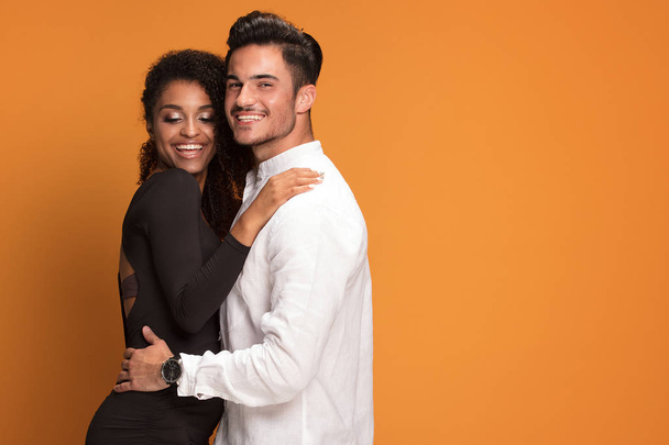 Happy beautiful mixed race couple. Smiling african american girl with handsome man posign together. - Photo, image