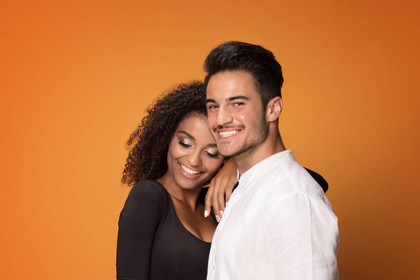 Happy beautiful mixed race couple. Smiling african american girl with handsome man posign together. - Foto, Bild