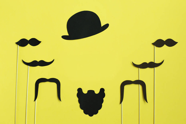 Happy Fathers Day. image of a man on paper. Beard and mustache on yellow background. Concept of prostate cancer - Photo, Image