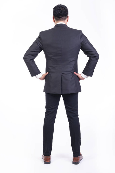 Businessman isolated in white background. Handsome young indian businessman in suit portrait, thinking, focus  looks. Full length back shot. - Valokuva, kuva