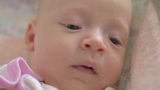 A closeup of a yawning baby girl face - Imágenes, Vídeo
