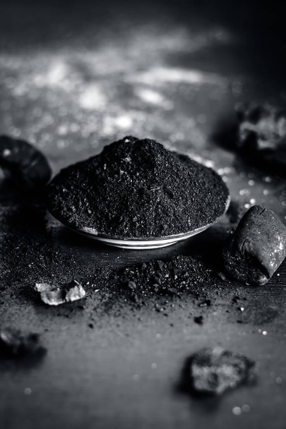 Close up of coal powder on wooden table - Fotó, kép