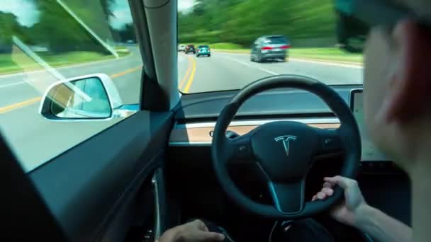 Person driving a new Tesla Model 3 in autopilot. The model 3 is set to be the Teslas first mass market electric vehicle - Video