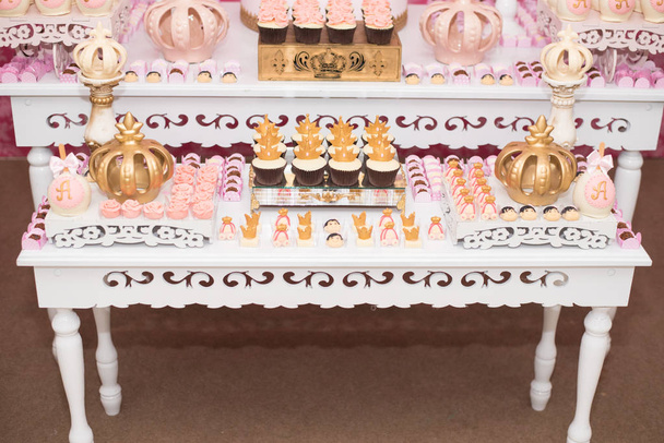 Mesa de aniversário com doces, tema da coroa
 - Foto, Imagem