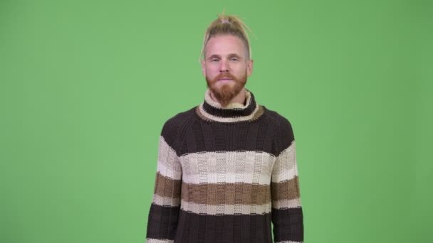Happy handsome bearded man with dreadlocks wearing warm clothing - Materiał filmowy, wideo