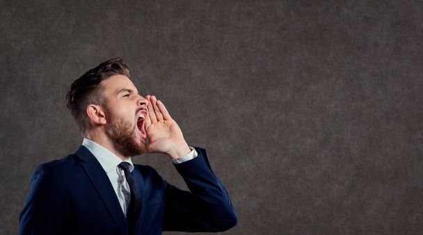 Young businessman with a beard screaming against. - Foto, imagen
