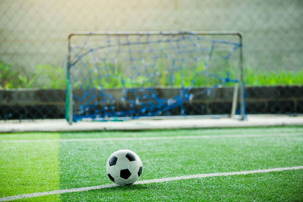 Football on green artificial turf with blurry in front of goal. It is for green background and the concept of situation. - 写真・画像