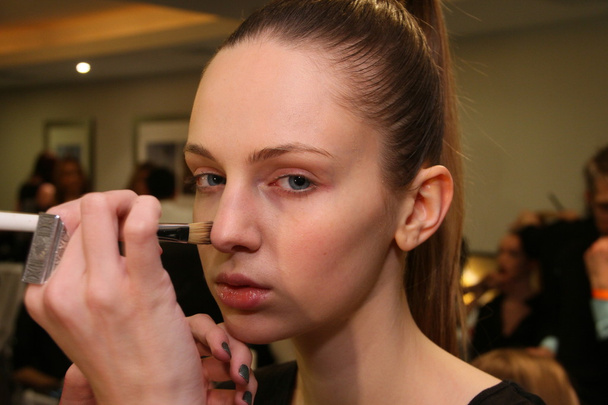 NEW YORK - FEBRUARY 10: A model gets ready backstage for Victor de Souza collection at the Strand hotel during Mercedes-Benz Fashion Week on February 10, 2013 in New York City - Zdjęcie, obraz
