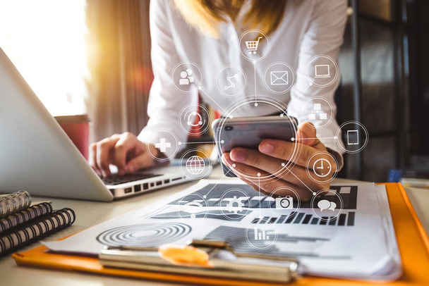  Woman using smart phone for mobile payments online shopping,omni channel,sitting on table,virtual icons graphics interface screen in morning light - Foto, Imagen