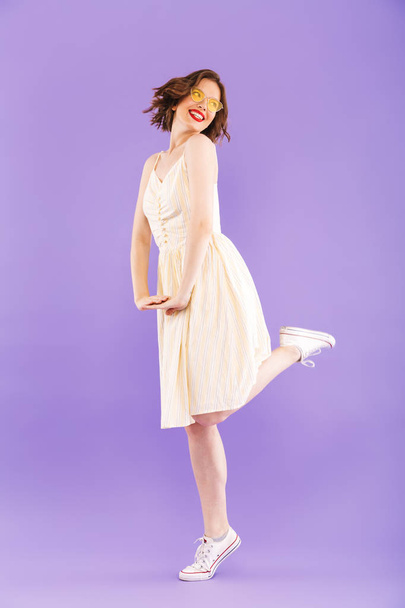Photo of amazing excited woman dancing isolated over purple wall background. - 写真・画像