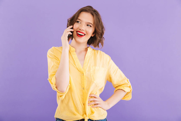 Image of happy woman isolated over purple wall background talking by mobile phone. - Foto, Imagem
