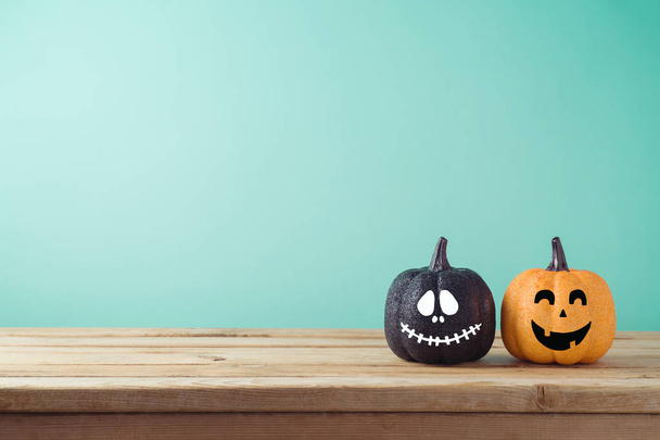 Halloween holiday concept with jack o lantern glitter pumpkins decor on wooden table - Φωτογραφία, εικόνα