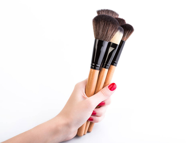 Various makeup brushes isolated over white. wooden makeup brushes. Duo fibre foundation makeup brush. Style. Fashion. Visage. Cosmetics. - Photo, Image