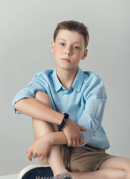 boy posing in fashionable shirt and shirts in studio - Foto, Imagen