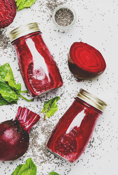 Delicious beetroot smoothies in glass bottles with chia on white food background, top view - Foto, immagini
