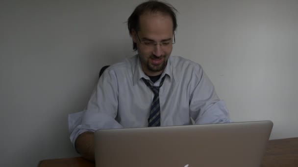Medium frontal shot of Office young businessman in shirt relaxed working with laptop - Materiaali, video