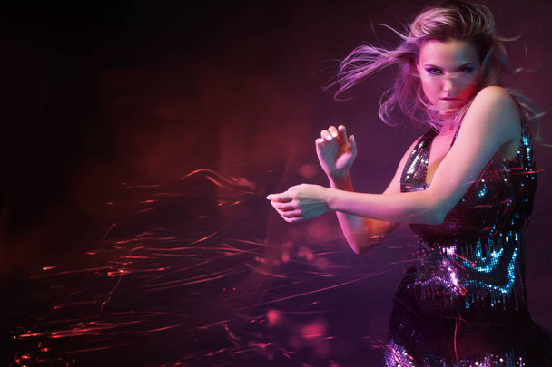 Bright and stylish young woman dancing in club, color light, motion effects - Φωτογραφία, εικόνα