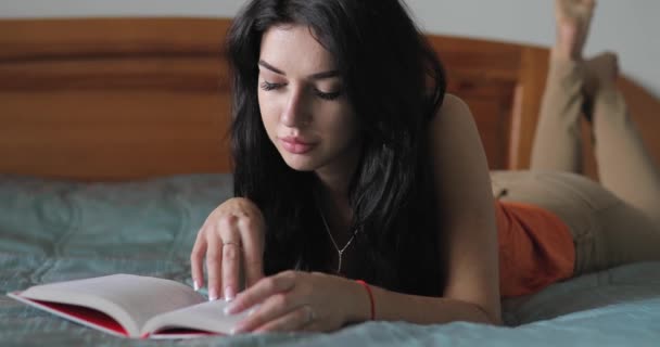 Woman reading book in home bed - Materiaali, video