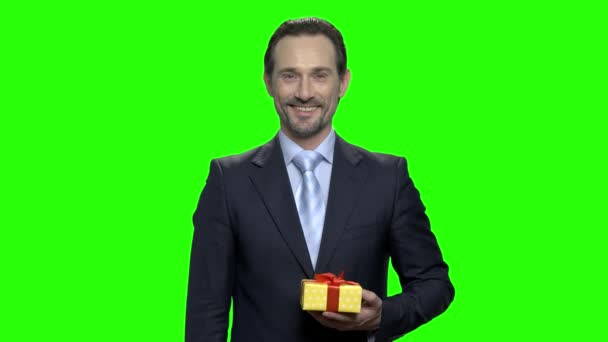 Portrait of smiling cheerful man giving you a present. - Footage, Video