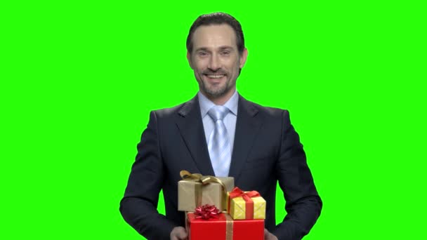 Positive handsome man giving presents. - Footage, Video
