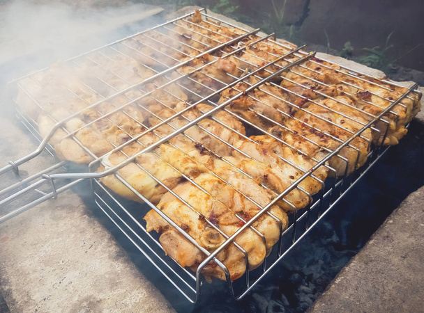 Shish kebab from a chicken on an improvised barbecue made of bricks. - Photo, Image