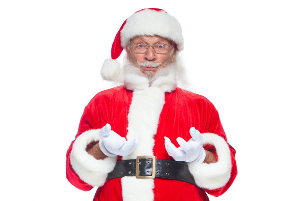 Christmas. Good Santa Claus in white gloves shows faces, grimaces, shows his tongue. Not standard behavior. Isolated on white background. - Photo, Image