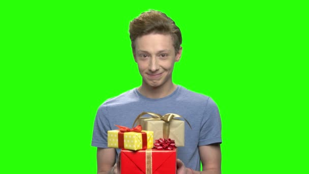 Portrait of teenage boy giving present gift boxes. - Footage, Video