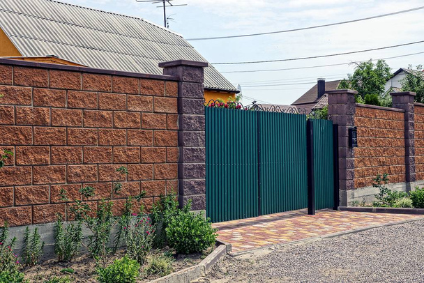 The green gate and the gate of iron and the brick brown fence - Photo, Image
